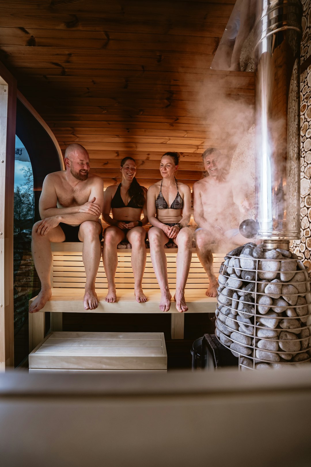 Four people relaxing in a steamy sauna